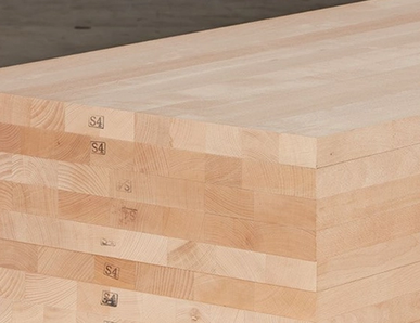 Gestapelte Massivholzplatten mit durchgehenden Lamellen, ideal für den Möbel- und Innenausbau.
